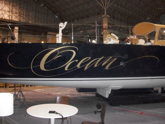 Name graphic in gold ettering on sides of yacht Waukegan, IL