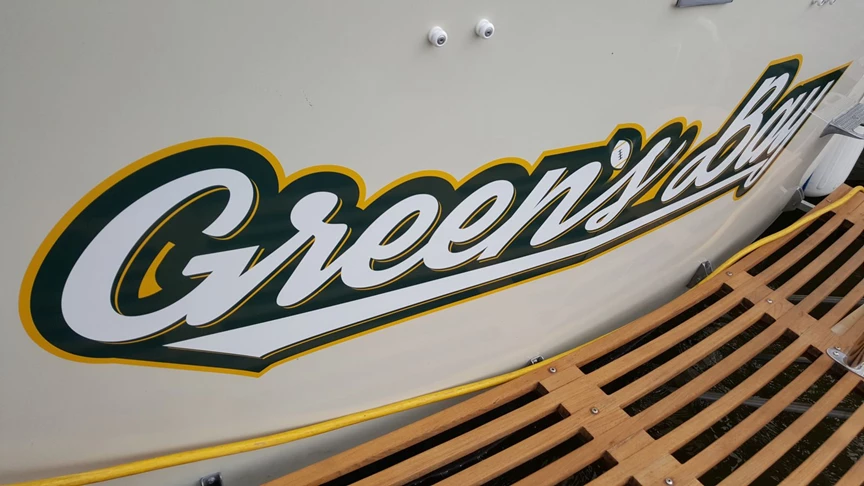 Color printed graphic on transom of classic Chris Craft boat. Applied in the water at dock on Pistakee Lake, part of the Fox Chain of Lakes in Lake County Illinois.