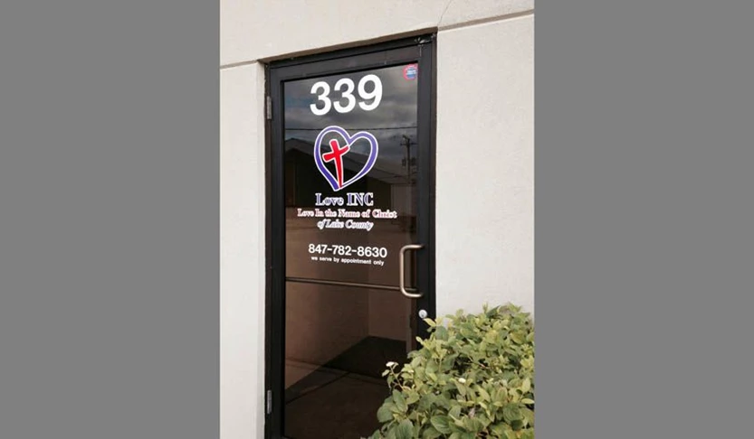 Door graphic with logo and lettering for Love INC. a non-profit supported by churches in Lake County IL.