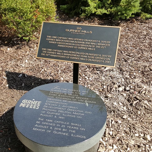 Bronze plaque on post for time capsule at Gurnee Mills mall