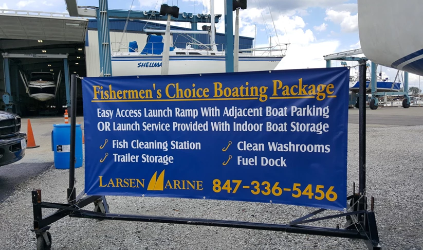 Outdoor banner with graphics advertising services offered at Larsen Marine.