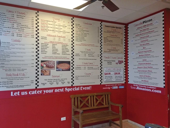 Large menu boards on wall of pizza chain restaurant